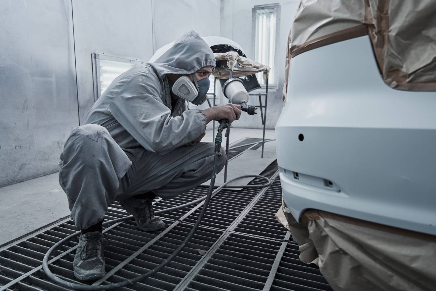 Person polishing a car with a machine