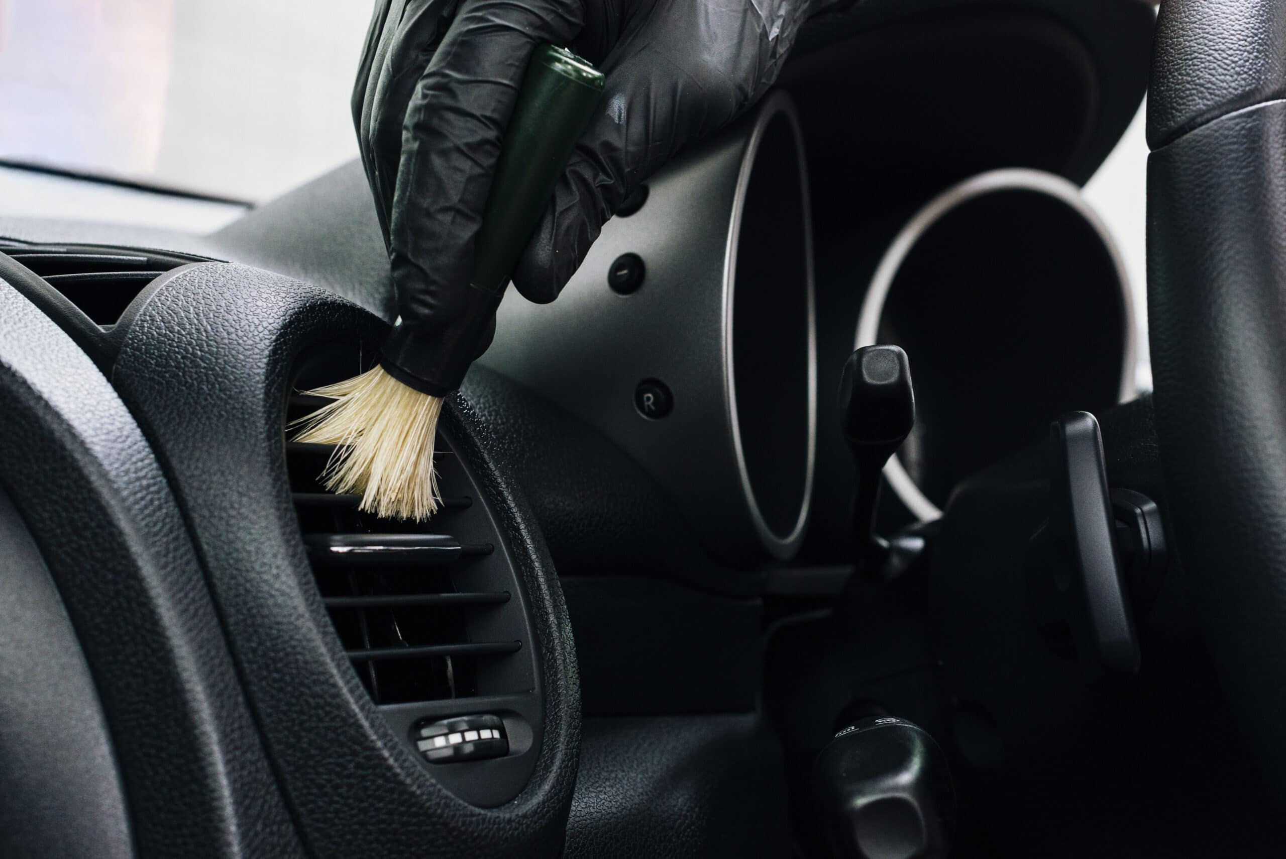 Person applying a coating to a car door