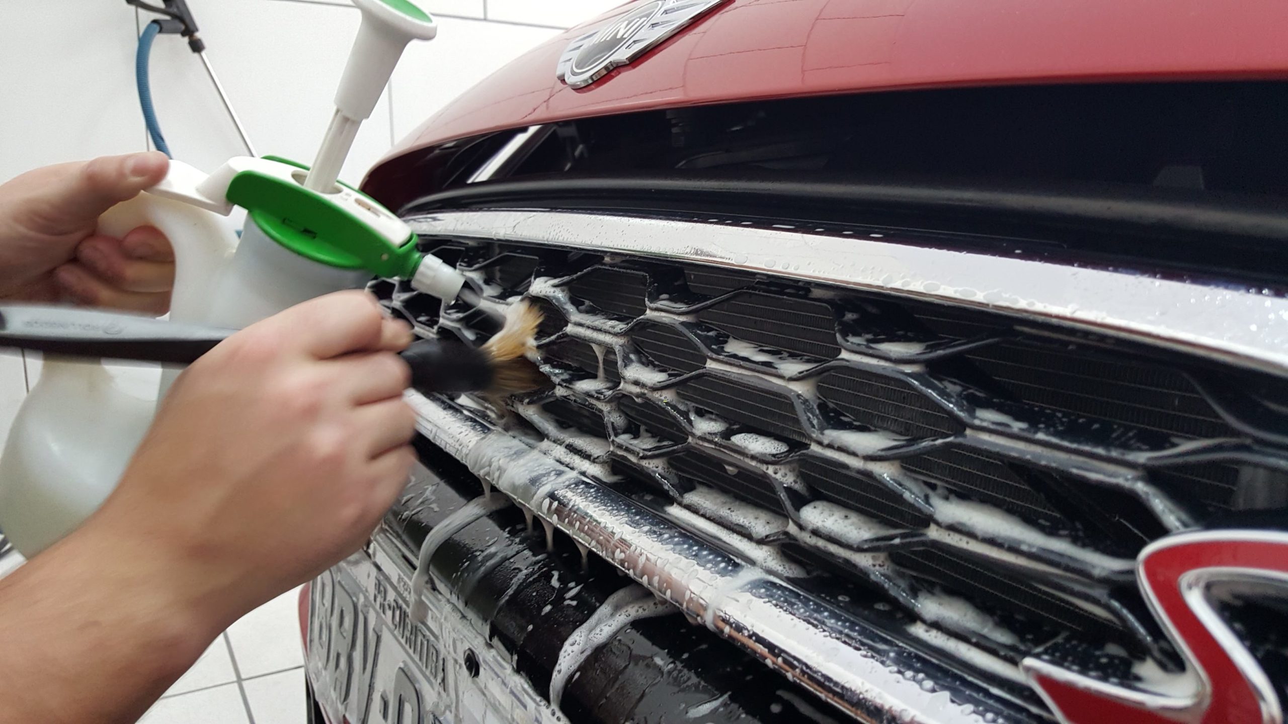 Person applying a coating to a car door