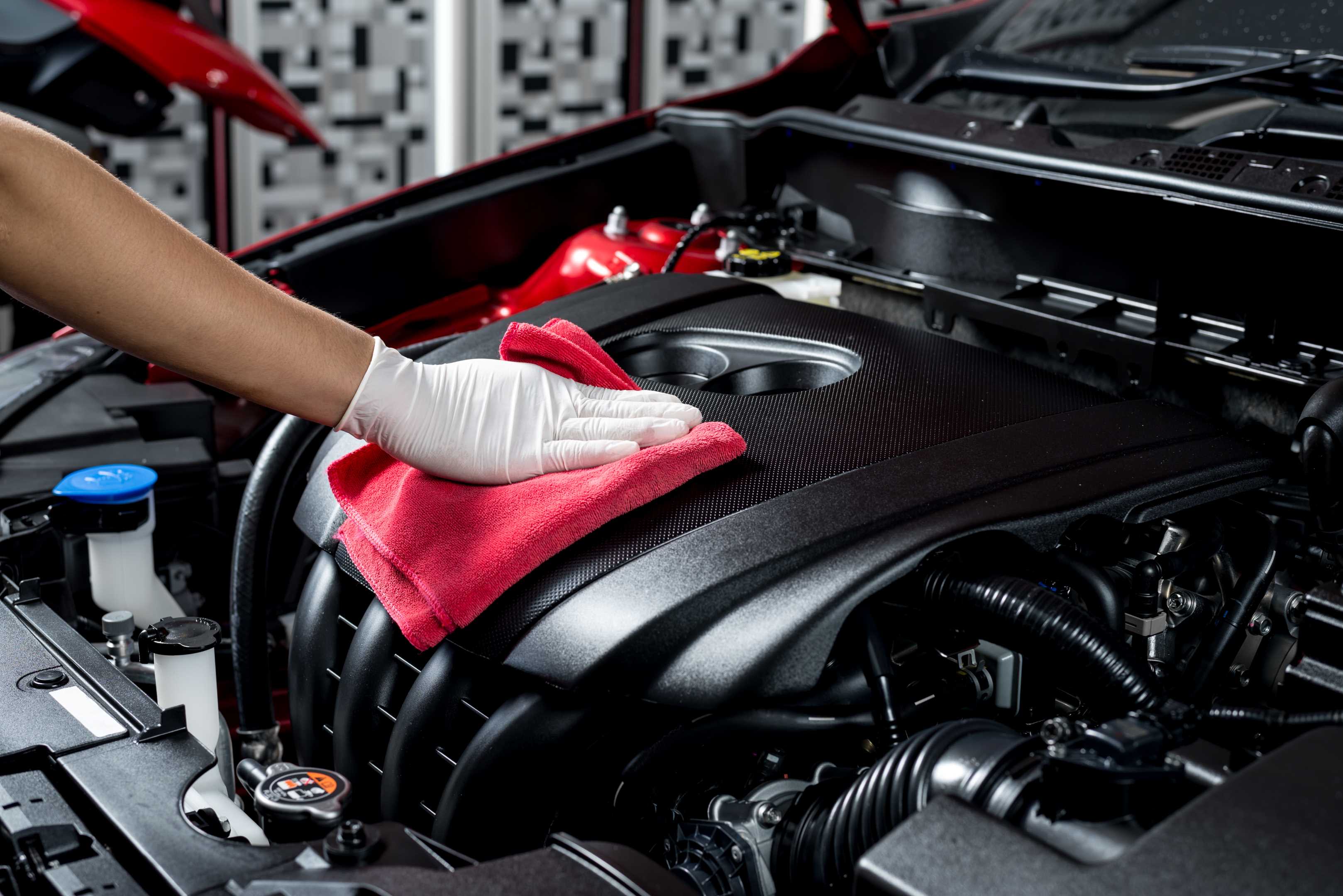 Person polishing a car with a machine