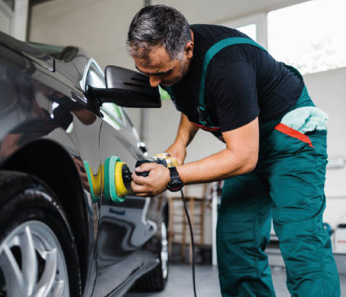 Person applying a coating to a car door