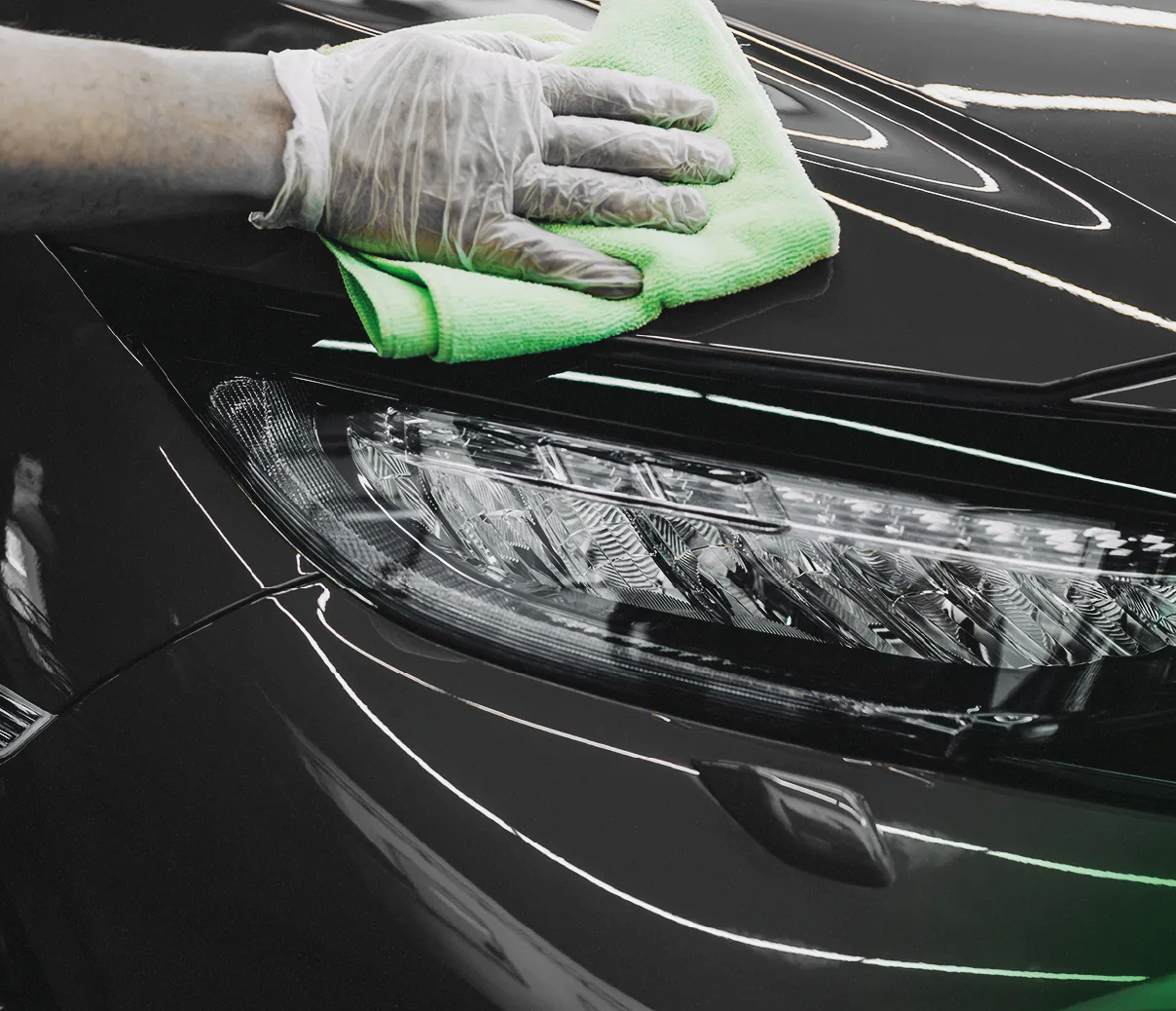 Close-up of a car headlight being polished