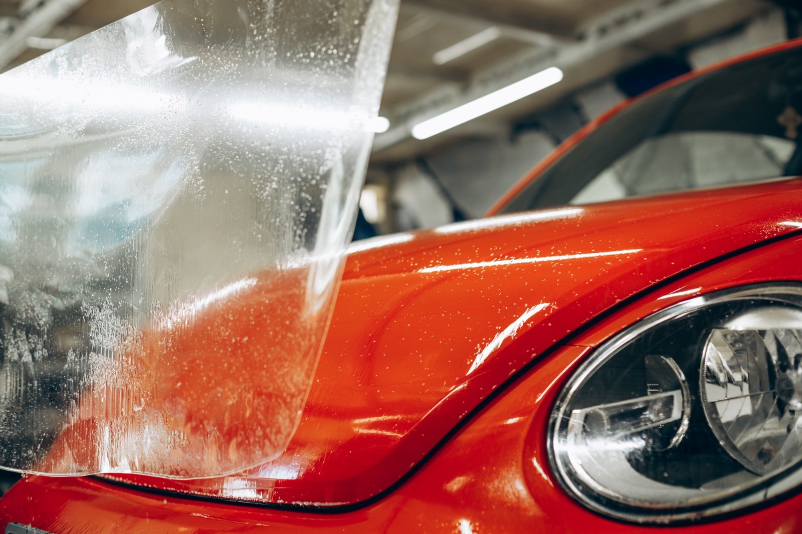 Close-up of a car headlight being polished