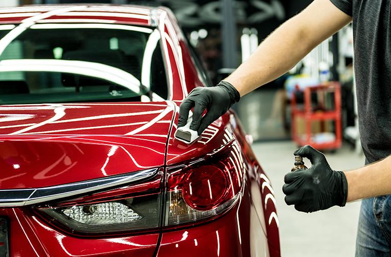 Close-up of a car headlight being polished
